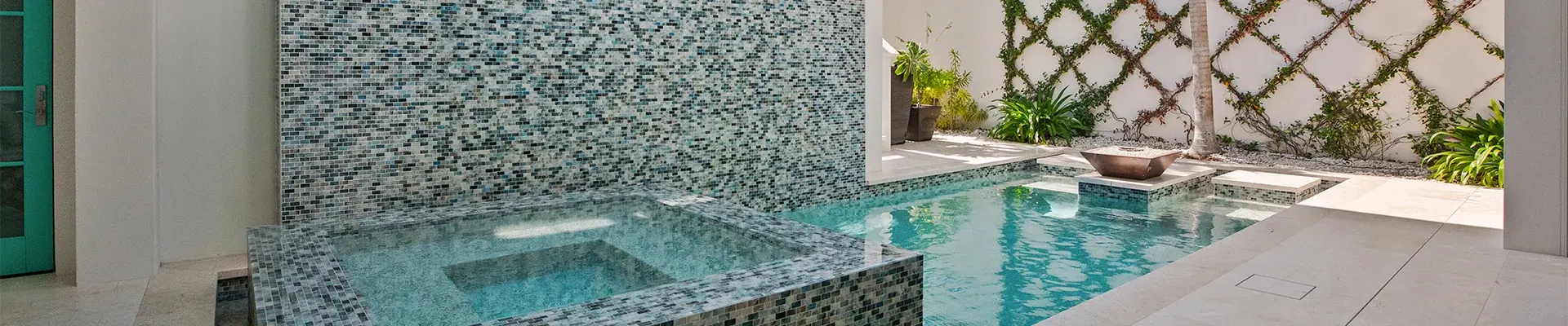 Glass mosaic spa and pool with fire bowl