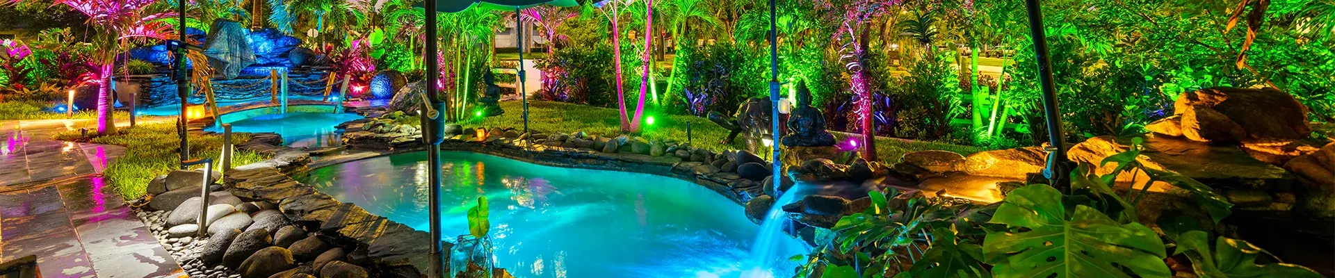 Tropical lagoon pool lit at night